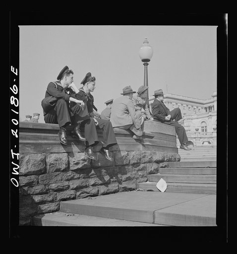 Washington, D.C. Sailors and civilians sitting on the Capitol grounds