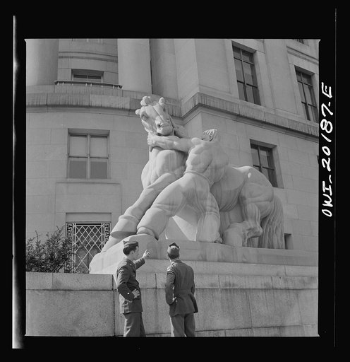 Washington, D.C. Soldiers looking at the statue in front of the Federal Trade Commission building