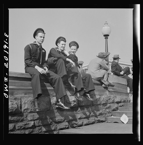 Washington, D.C. Sailors and civilians sitting on the Captiol grounds