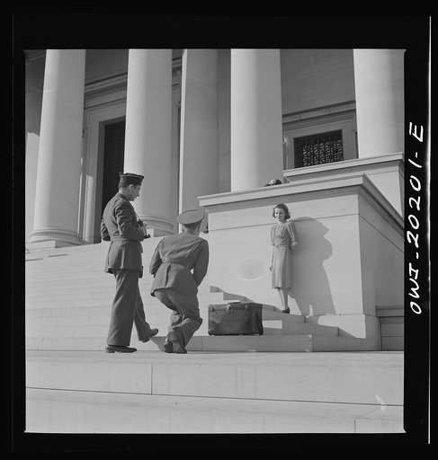 Washington, D.C. Soldiers taking pictures of a girl on the steps of the National Gallery of Art on a Sunday afternoon