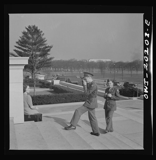 Washington, D.C. Soldier taking pictures on the steps of the National Gallery of Art on a Sunday afternoon