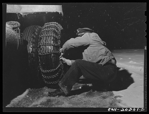 Jim Fletcher stopping to put on chains while crossing the Blue Ridge Mountains in Tennessee during a snow storm