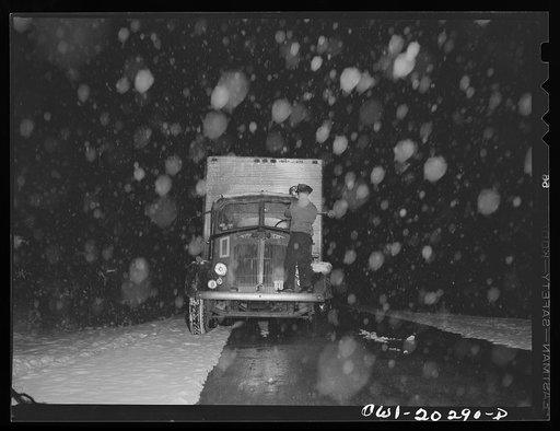 Jim Fletcher stopping to wipe off the windshield at the beginning of a snow storm near Elizabethton, Tennessee