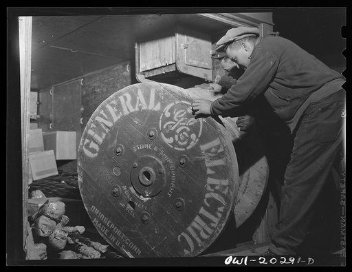 Baltimore, Maryland. Loading a roll of cable wire onto a truck at Davidson truck terminal