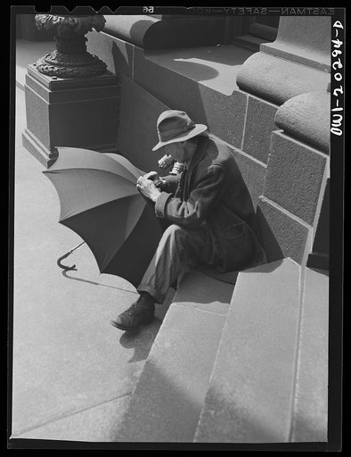 Baltimore, Maryland. A man repairing an umbrella