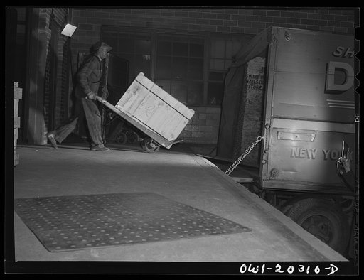Untitled photo, possibly related to: Baltimore, Maryland. Loading ammunition onto a truck at the Davidson truck terminal