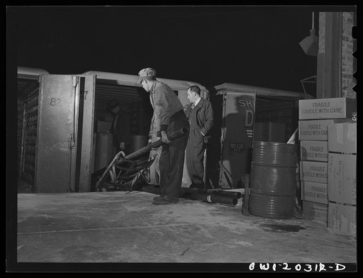Untitled photo, possibly related to: Baltimore, Maryland. Loading ammunition onto a truck at the Davidson truck terminal