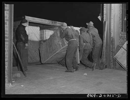 Baltimore, Maryland. Platform workers crated machinery onto a truck at the Davidson truck terminal