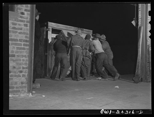 Baltimore, Maryland. Platform workers loading crated machinery onto a truck at the Davidson truck terminal