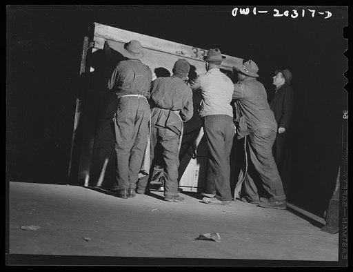 Untitled photo, possibly related to: Baltimore, Maryland. Platform workers crated machinery onto a truck at the Davidson truck terminal