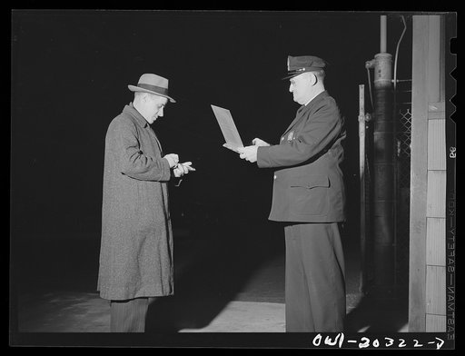Baltimore, Maryland. Terminal office employee showing his identification badge to the guard before entering the Davidson truck terminal