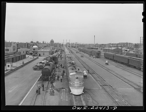 Untitled photo, possibly related to: Albuquerque, New Mexico. The Atchison, Topeka and Santa Fe Railroad streamliner "Super Chief" stopping for five minutes' servicing at the depot