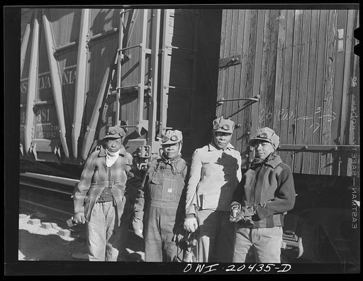 Untitled photo, possibly related to: Clovis, New Mexico. Left to right: Almeta Williams, Beatrice Davis, Liza Goss and Abbie Caldwell, employed at the Atchison, Topeka and Santa Fe Railroad yard to clean out potash cars