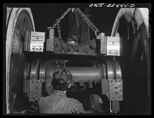 Albuquerque, New Mexico. Lowering half of a locomotive housing onto roller bearings of the driver wheel axle in the Atchison, Topeka and Santa Fe Railroad wheel shop