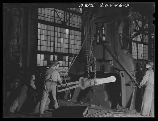 Untitled photo, possibly related to: Albuquerque, New Mexico. Hammering out a drawbar under the steam hammer at the Atchison, Topeka and Santa Fe Railroad blacksmith shop