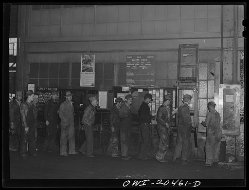 Albuquerque, New Mexico. Men checking out for lunch at the Atchison, Topeka and Santa Fe locomotive shops