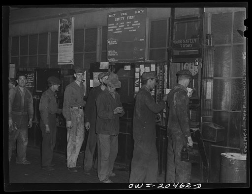 Albuquerque, New Mexico. Men checking out for lunch at the Atchison, Topeka and Santa Fe locomotive shops