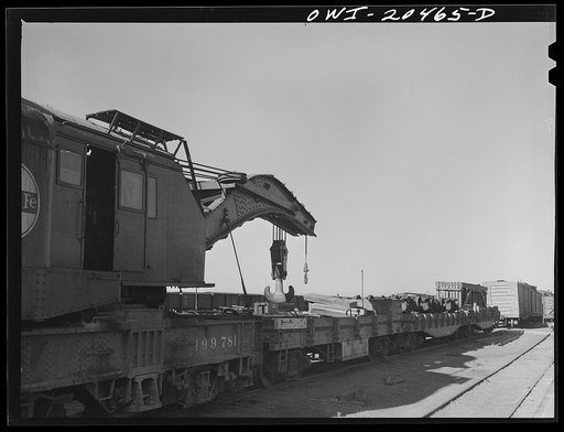 Clovis, New Mexico. A wrecker on the Atchison, Topeka and Santa Fe Railroad. Note derrick and cars loaded with wheels, trucks, ties and spare parts