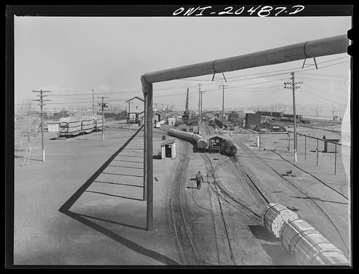 Untitled photo, possibly related to: Albuquerque, New Mexico. At the Atchison, Topeka and Santa Fe Railroad tie treating plant. The steaming black ties on the left have just come out of the retorts after having been treated for eight hours