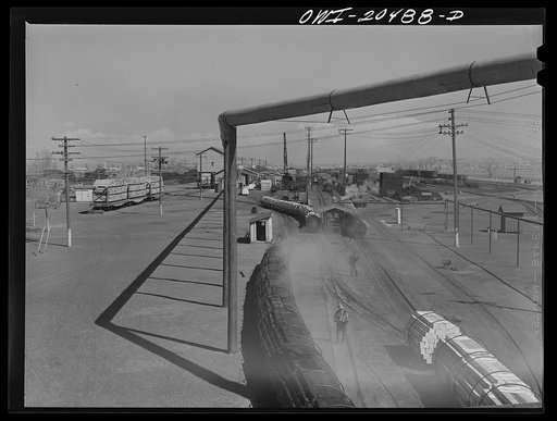 Albuquerque, New Mexico. At the Atchison, Topeka and Santa Fe Railroad tie treating plant. The steaming black ties on the left have just come out of the retorts after having been treated for eight hours