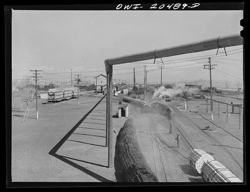 Untitled photo, possibly related to: Albuquerque, New Mexico. At the Atchison, Topeka and Santa Fe Railroad tie treating plant. The steaming black ties on the left have just come out of the retorts after having been treated for eight hours