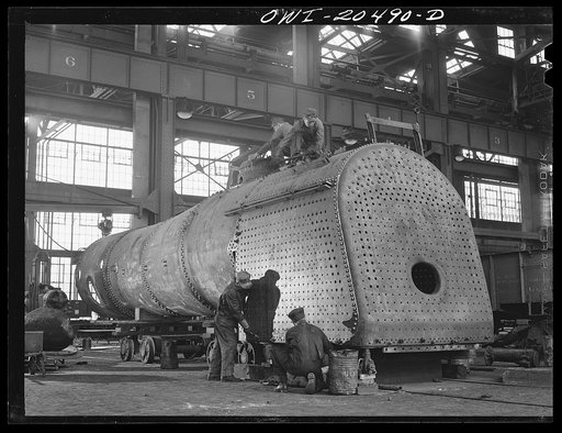 Albuquerque, New Mexico. Working on the fire box of an engine in the Atchison, Topeka and Santa Fe Railroad locomotive shops