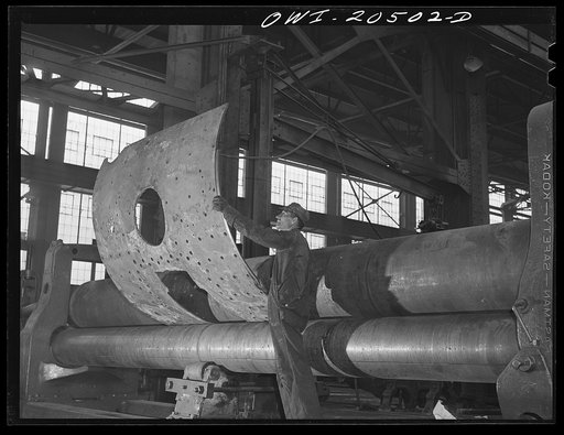 Albuquerque, New Mexico. Rolling a boiler smoke box sheet in the Atchison, Topeka and Santa Fe Railroad locomotive shops