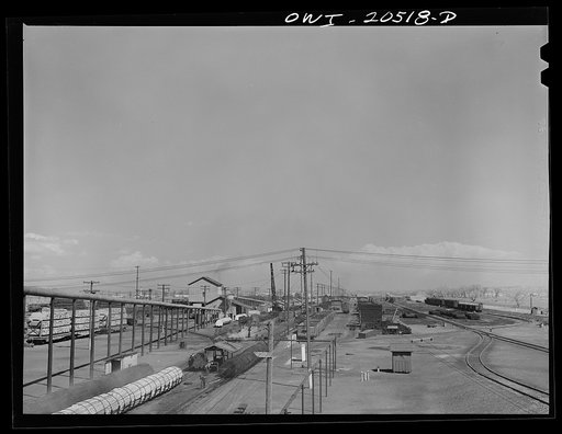 Untitled photo, possibly related to: Albuquerque, New Mexico. At the Atchison, Topeka and Santa Fe Railroad tie treating plant. Black ties have just come out of the retort where they were treated for eight hours. Light colored ties are about to go into the retort