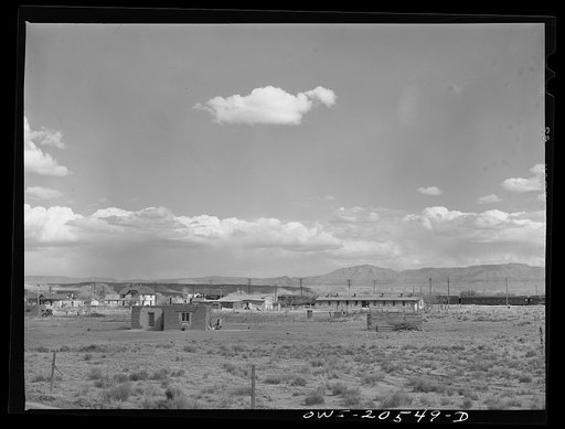 Los Lunas, New Mexico. Part of the town. A troop train passing in the background