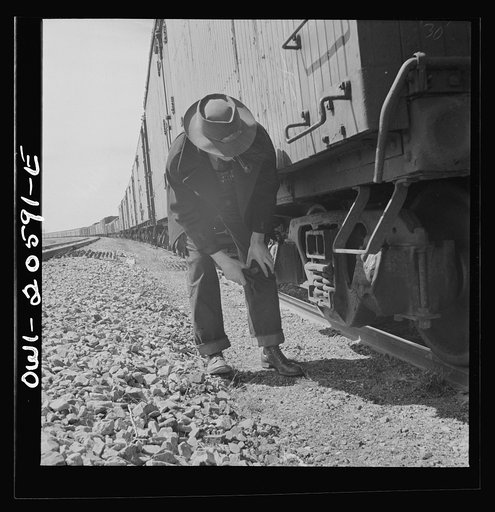 Untitled photo, possibly related to: Black, Texas. Conductor reading his train orders as the train on the Atchison, Topeka, and Santa Fe Railroad between Amarillo, Texas and Clovis, New Mexico waits in a siding