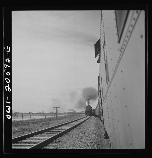 Parmerton, Texas. Passing an eastbound freight train on the Atchison, Topeka and Santa Fe Railroad between Amarillo, Texas and Clovis, New Mexico