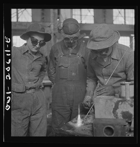 Clovis, New Mexico. Soldiers of the United States Army Railroad Battalion study welding at the locomotive shops in the Atchison, Topeka and Santa Fe Railroad. Left to right: Private Edward Dravis of Minnesota; Earl Weidinger, instructor and welder; and Sergeant Arthur Cannon of Indiana