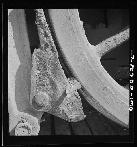 Clovis, New Mexico. Refacing the tires of a locomotive with a Ledgerwood apparatus. The locomotive is drawn down the rails by a cable, while cutting edges inserted in the brake shoes does the refacing in the Atchison, Topeka and Santa Fe Railroad shops