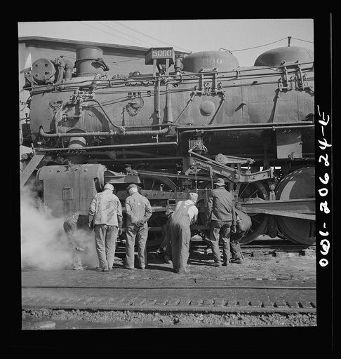 Clovis, New Mexico. Checking a locomotive as it leaves the roundhouse in the Atchison, Topeka and Santa Fe Railroad shops