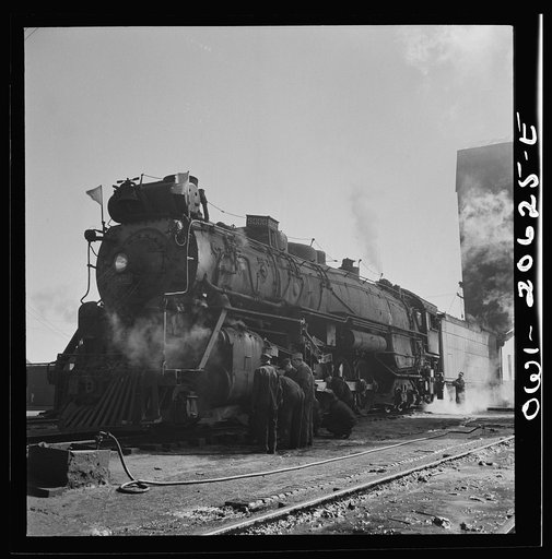 Untitled photo, possibly related to: Clovis, New Mexico. Checking a locomotive as it leaves the roundhouse in the Atchison, Topeka and Santa Fe Railroad shops