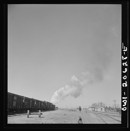 Untitled photo, possibly related to: Clovis, New Mexico. Westbound freight train leaving the Atchison, Topeka and Santa Fe Railroad