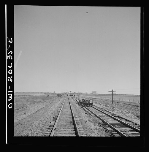 Clovis, New Mexico. Passing a section gang at work on the outskirts along the Atchison, Topeka, and Santa Fe Railroad between Clovis and Vaughn, New Mexico