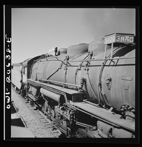 Untitled photo, possibly related to: Melrose, New Mexico. Train stopping for water along the Atchison, Topeka, and Santa Fe Railroad