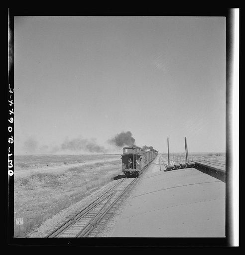 Tolar, New Mexico. Passing an east bound freight train along the Atchison, Topeka, and Santa Fe Railroad between Clovis and Vaughn, New Mexico