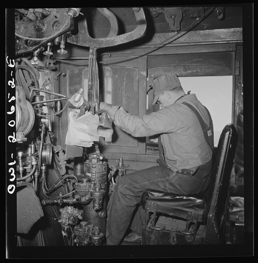 Untitled photo, possibly related to: Ricardo, New Mexico. Engineer in his cab about to start the train along the Atchison, Topeka, and Santa Fe Railroad between Clovis and Vaughn, New Mexico