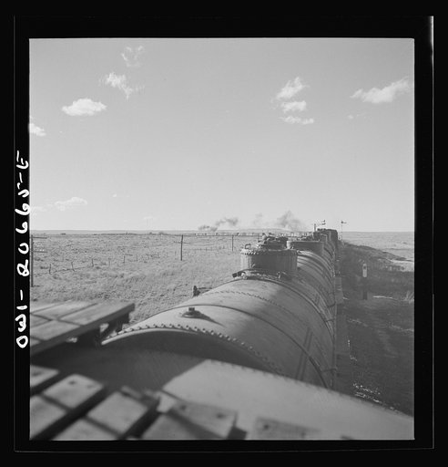 Untitled photo, possibly related to: Buchanan, New Mexico. Passing an eastbound freight along the Atchison, Topeka, and Santa Fe Railroad between Clovis and Vaughn, New Mexico