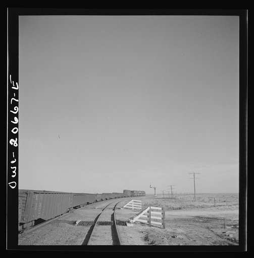 Buchanan, New Mexico. Passing an eastbound diesel freight train along the Atchison, Topeka, and Santa Fe Railroad between Clovis and Vaughn, New Mexico
