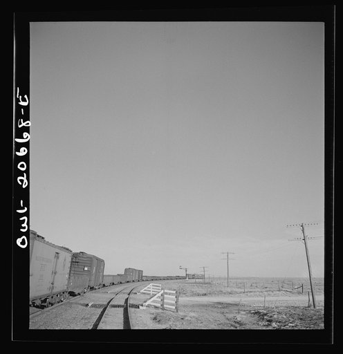 Untitled photo, possibly related to: Buchanan, New Mexico. Passing an eastbound diesel freight train along the Atchison, Topeka, and Santa Fe Railroad between Clovis and Vaughn, New Mexico