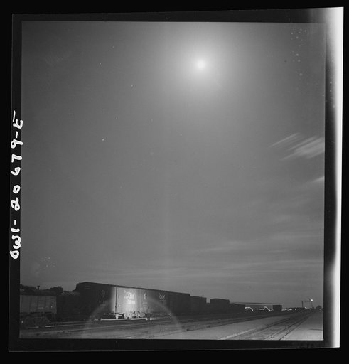 Vaughn, New Mexico. Train inspector at work in the Atchison, Topeka and Santa Fe Railroad yard, between Clovis and Vaughn, New Mexico