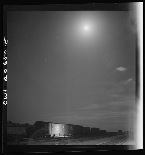 Untitled photo, possibly related to: Vaughn, New Mexico. Train inspector at work in the Atchison, Topeka and Santa Fe Railroad yard, between Clovis and Vaughn, New Mexico