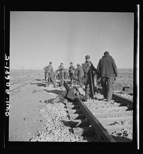 Iden, New Mexico. Section gang raising, surfacing and gauging the track in the Atchison, Topeka and Santa Fe Railroad between Clovis and Vaughn