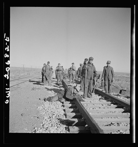 Untitled photo, possibly related to: Iden, New Mexico. Section gang raising, surfacing and gauging the track in the Atchison, Topeka and Santa Fe Railroad between Clovis and Vaughn