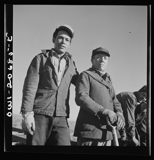 Iden, New Mexico. Joe Melende, left, and E. Argonne of Mountainair, New Mexico. Section workers on a job in the Atchison, Topeka and Santa Fe Railroad yard, between Clovis and Vaughn, New Mexico