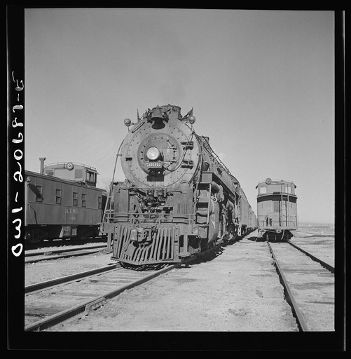 Untitled photo, possibly related to: Vaughn, New Mexico. Easternbound train about to leave the Atchison, Topeka and Santa Fe Railroad yard on the return trip