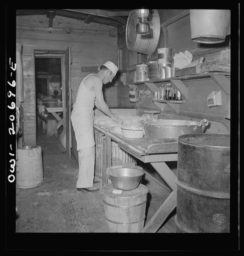 Iden, New Mexico. Baking bread in the kitchen car of the work train on the Atchison, Topeka and Santa Fe Railroad yard between Clovis and Vaughn, New Mexico